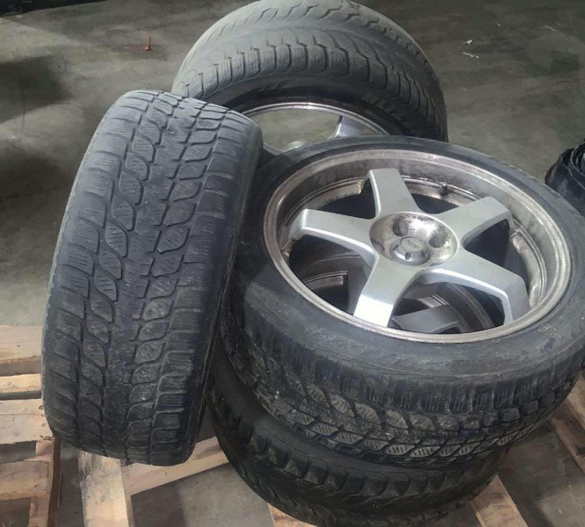 Set of four BLIZZAK tires on rim. Were used on a BMW 750Li (LOCATED IN IOWA, RIGGING INCLUDED WITH