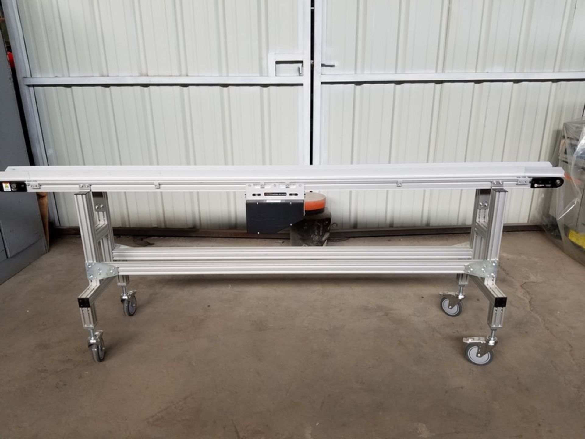 Aprox. 4" wide x 102" long x 36" high belt conveyor, casters (Handling, Loading & Site