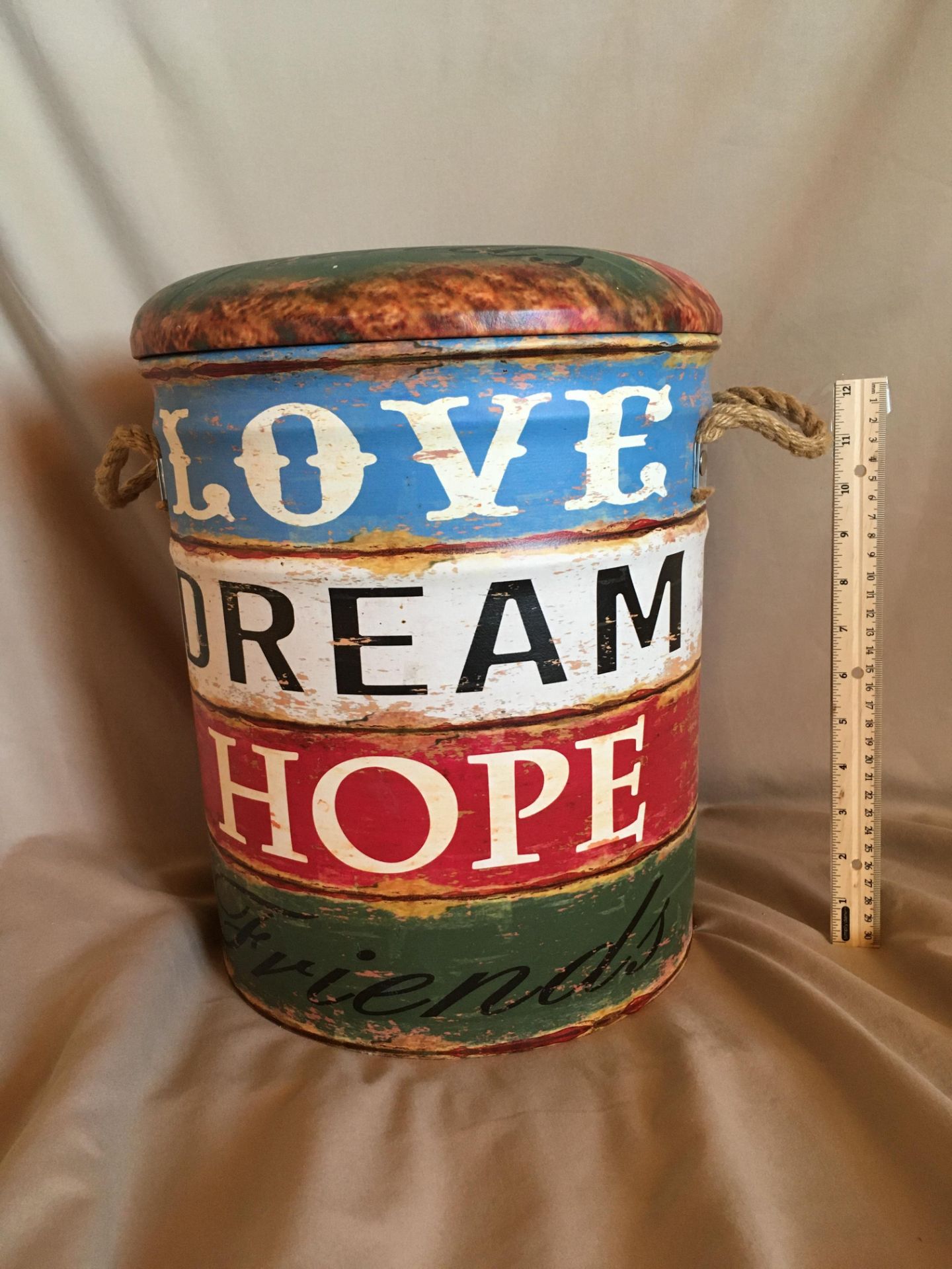 "LOVE, DREAM, HOPE" GARDEN OTTOMAN This ottoman is made out of metal and has a padded top for