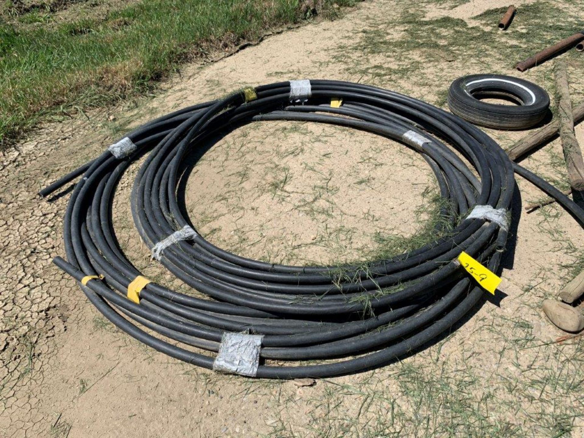 25-9 ROLL OF BLACK POLY HOSE 1" ID - LOCATED AT VAN STRYLAND FARMS CLIVE CALL CRAIG TO VIEW 403-