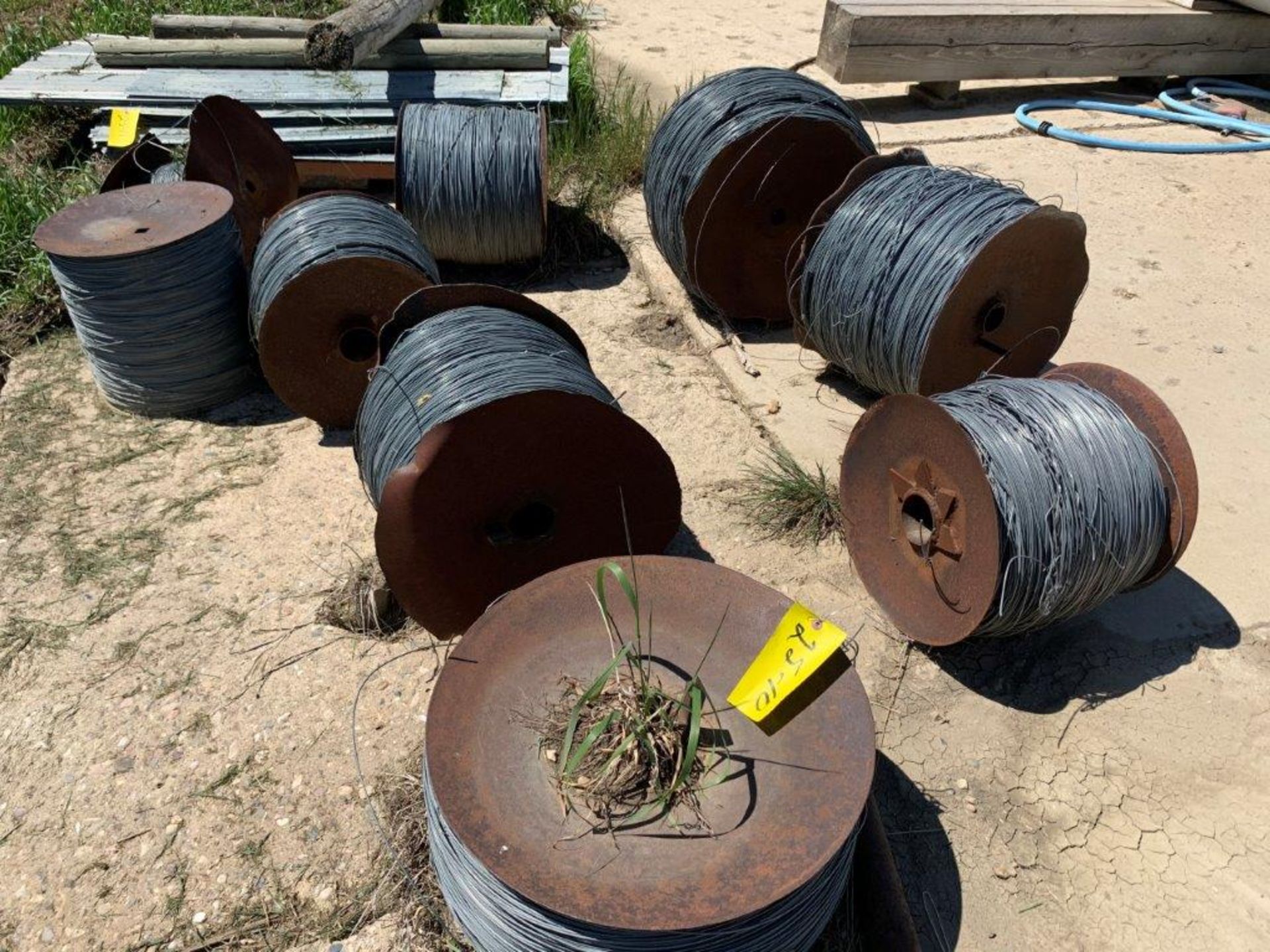 25-10 10-ROLLS OF SMOOTH HI-TENSILE WIRE (USED) - LOCATED AT VAN STRYLAND FARMS CLIVE CALL CRAIG