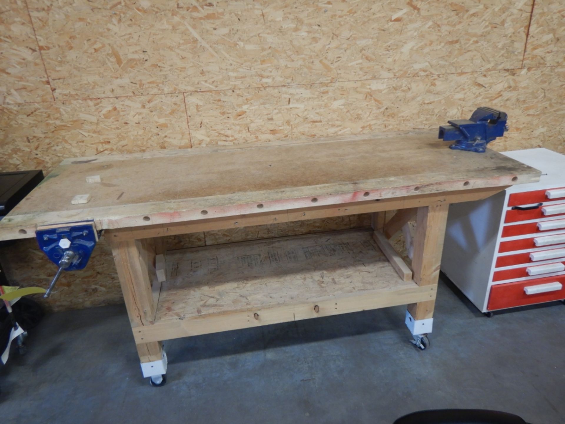 WOODEN SHOP BUILT WORK TABLE W/ 5IN BENCH VISE ON WHEELS - 80INX30INX36IN