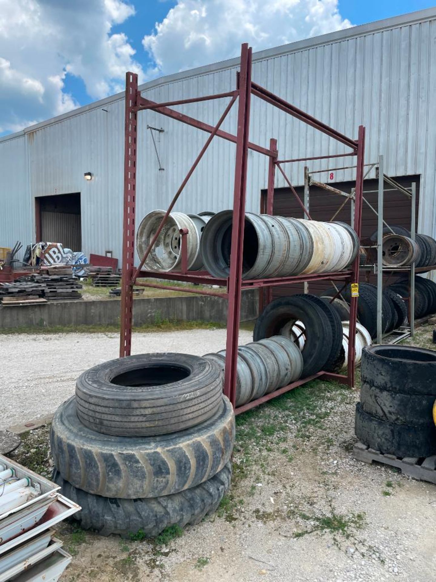 (3) TIRE RACKS AND ASSORTED NEW AND USED TIRES