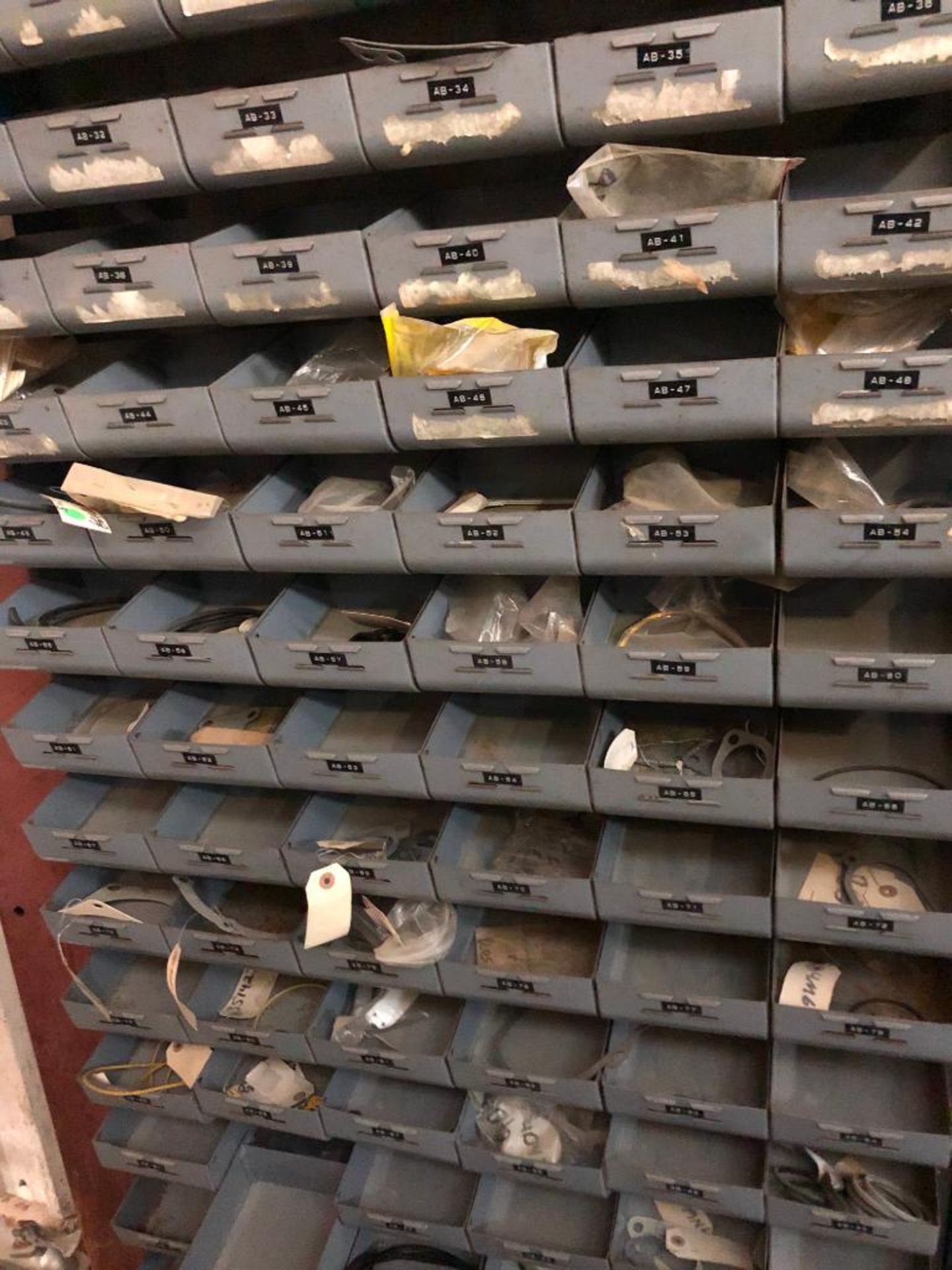 (5) ROWS OF SHELVES W/ DIVIDERS & PIGEON HOLES, SOME CONSISTING OF NEW CATERPILLAR SURPLUS - Image 12 of 25