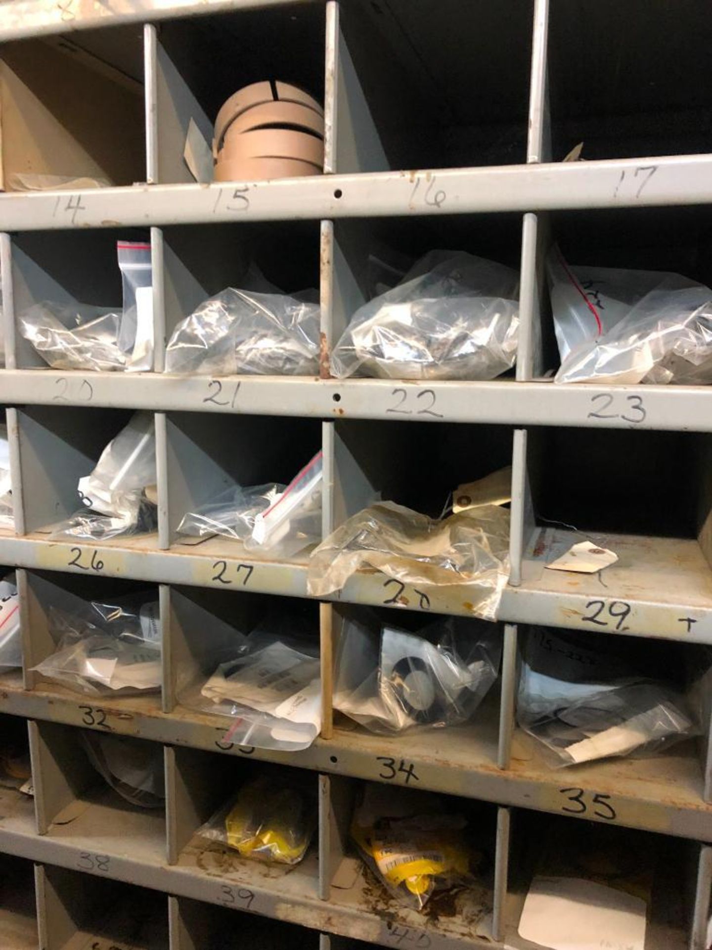 (5) ROWS OF SHELVES W/ DIVIDERS & PIGEON HOLES, SOME CONSISTING OF NEW CATERPILLAR SURPLUS - Image 17 of 25