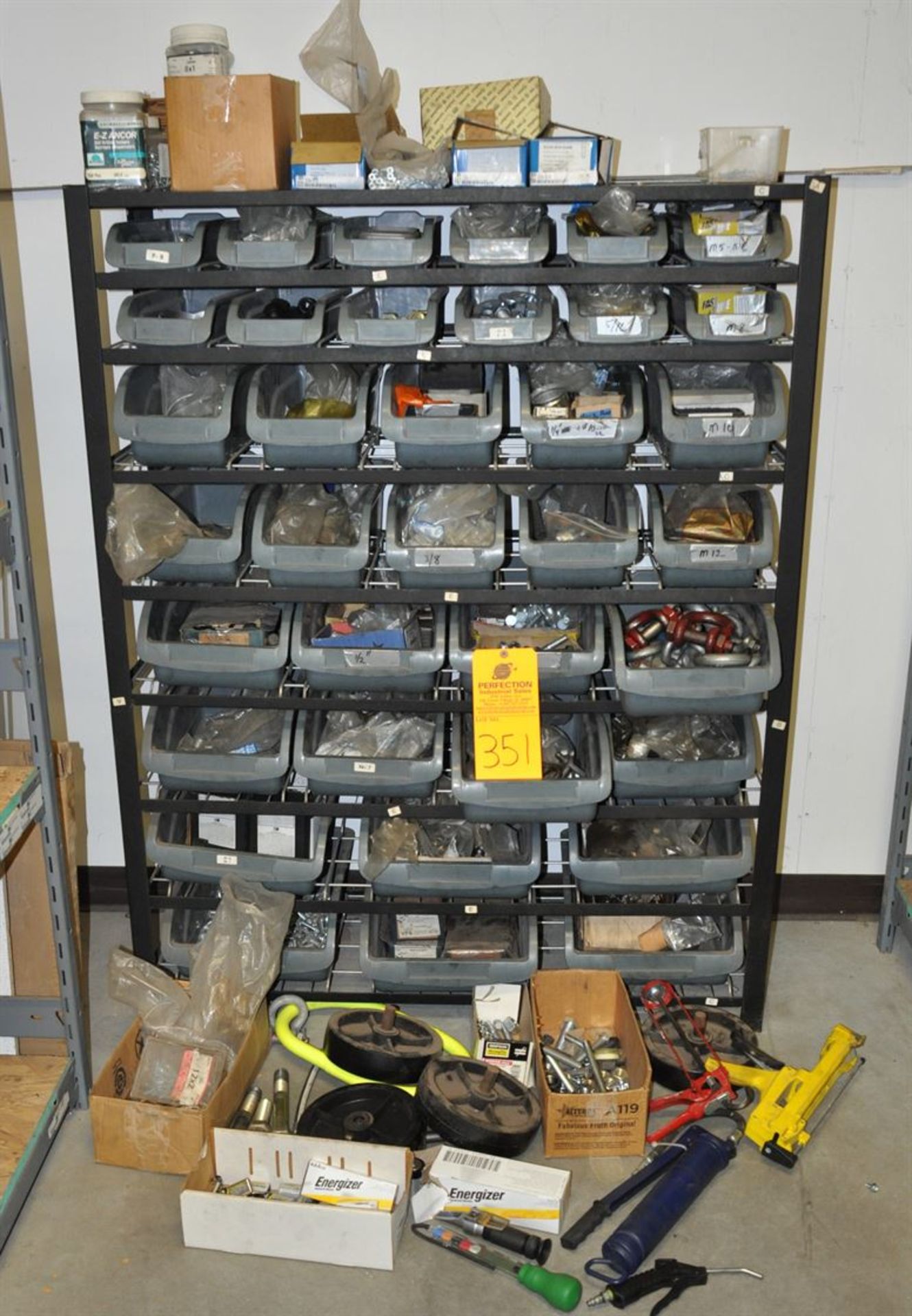 Mixed lot of nuts and bolts, shackles, etc. Includes shelf unit with bins