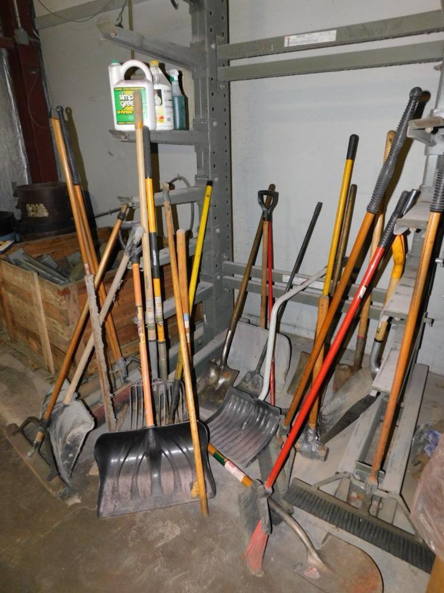 LOT: Large Quantity of Cleaning Tools including Brooms, Shovels, Pitchforks, Pick Axe, Scraper, etc.