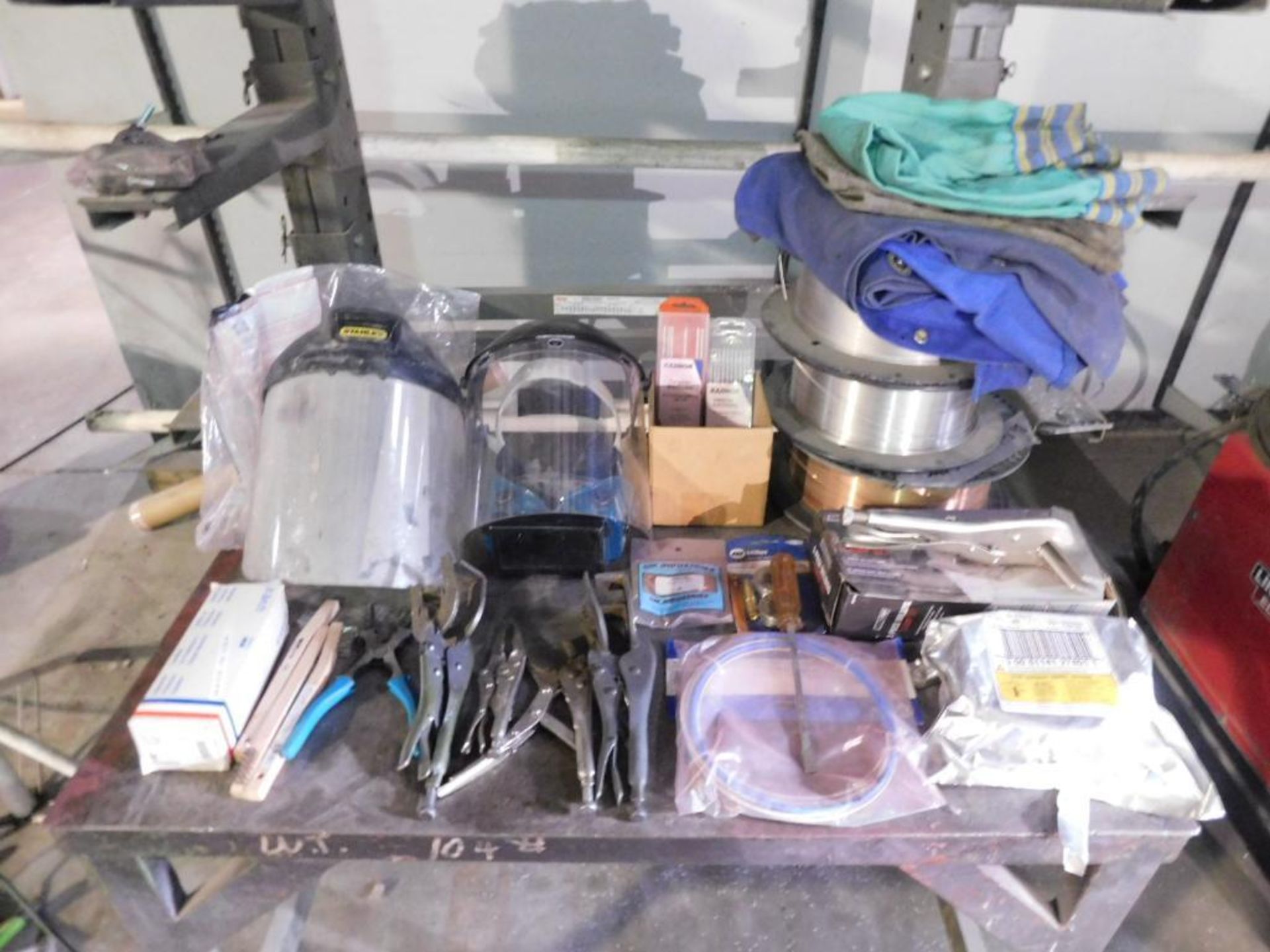 LOT: Contents of Cart including Welding Supplies & Gear, (3) Rolls of Welding Wire, Clamps, Face Shi