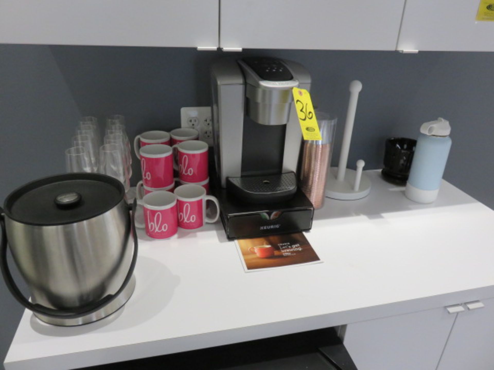 KEURIG COFFEE MAKER, STAND, ICE BUCKET, GLASSES, MUGS AND SUPPLIES