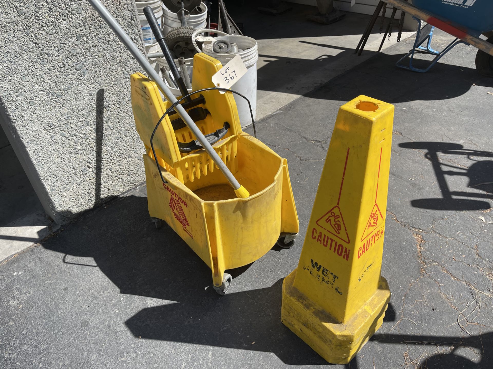 Janitorial mop bucket and three caution cones