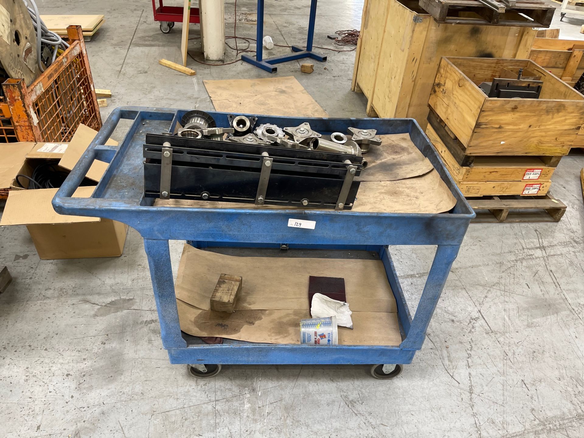 Blue plastic shop cart with contents