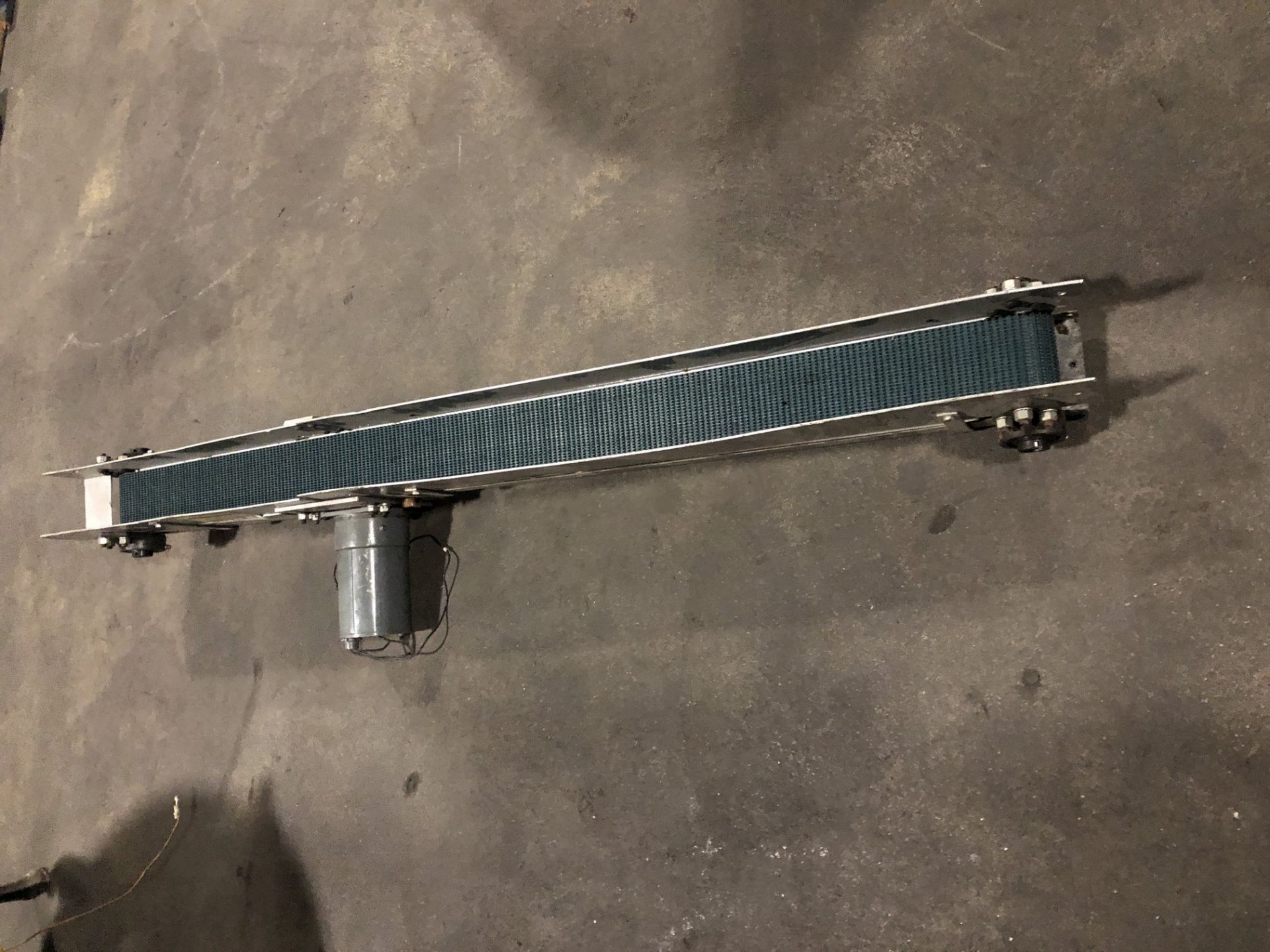 Conveyor with 3.5” wide x 54” long rubber belt conveyor without legs with motor. Located in - Image 2 of 3