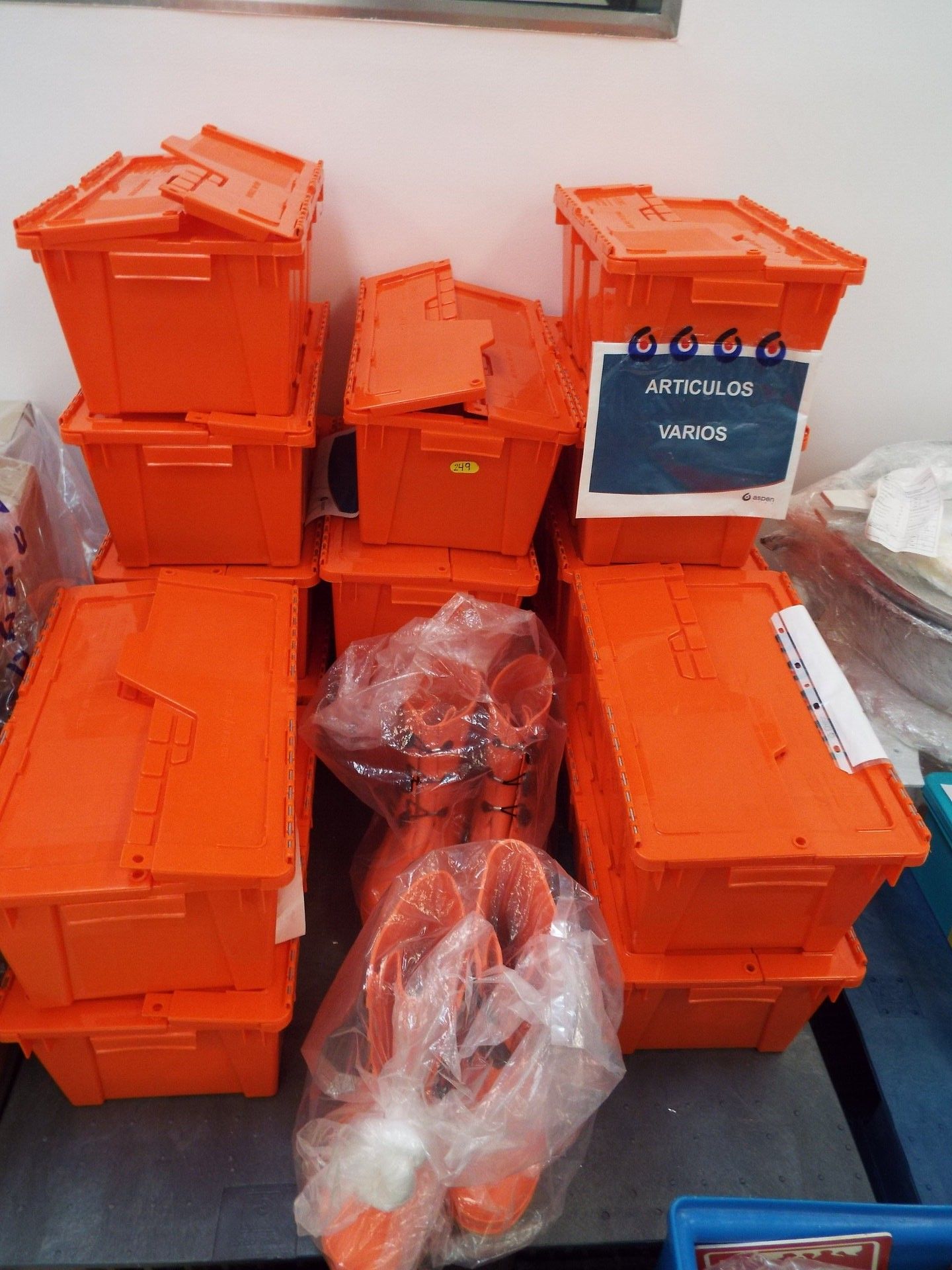 Lot of several safety devices (15 orange plastic boxes) and boots