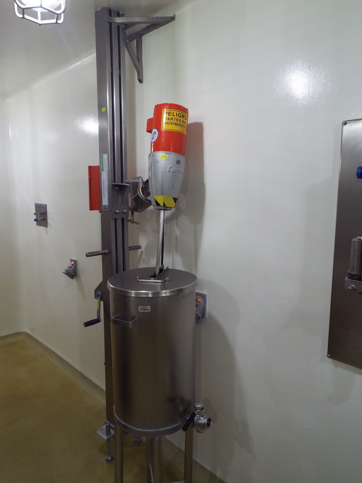60 liter stainless steel tank with Eastern agitator mounted over stainless steel mechanical elevator