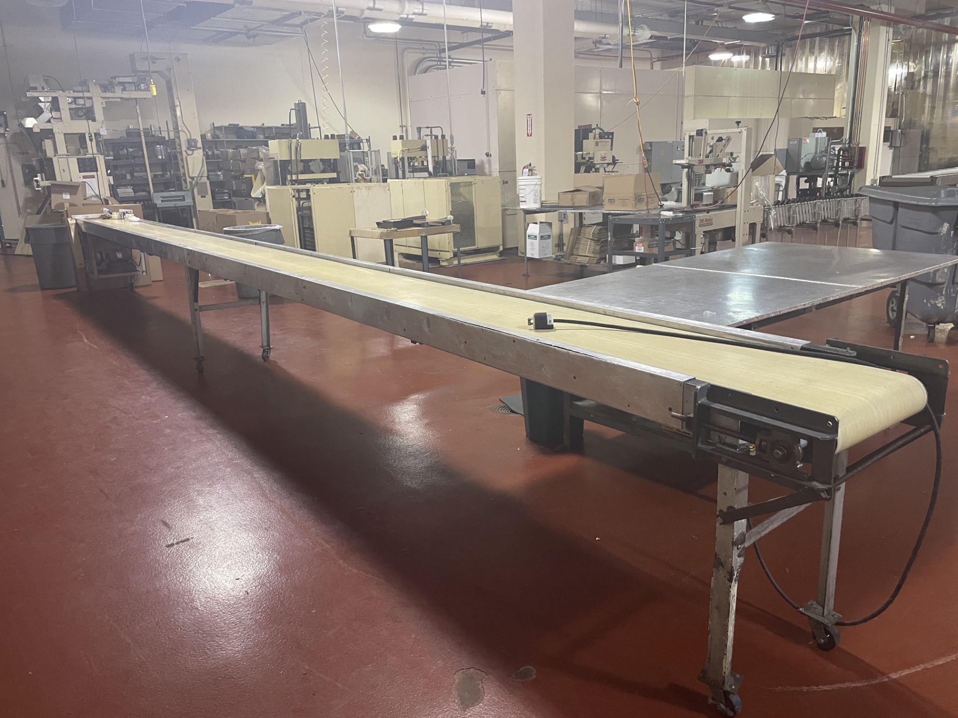 16" wide x 30-ft long x 36" tall packing conveyor on casters