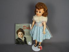 Ideal - A 20" Revlon doll by Ideal 1950's VT20 Brunette rooted doll with hairnet in original outfit,