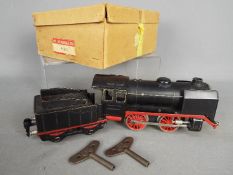 Marklin - A boxed O Gauge Marklin 0-4-0 Clockwork steam locomotive and tender R910 in black and red