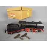 Marklin - A boxed O Gauge Marklin 0-4-0 Clockwork steam locomotive and tender R910 in black and red