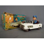 Nomura (TN Toys of Japan) - A boxed battery operated tinplate Mystery Police Car by Nomura (TN