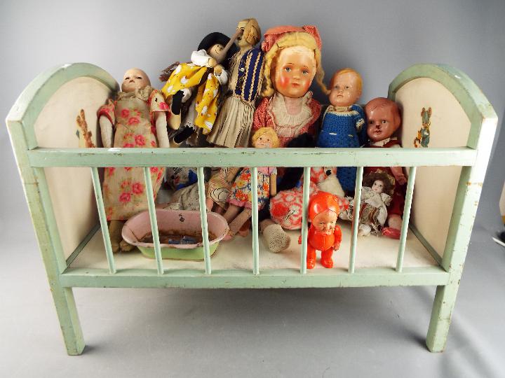 A vintage childrens dolls cot measuring approximately 50cms (H) x 70cms (L) x 40cms (W)with a