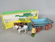Britains - A boxed Farm Waggon #5F in blue with red spoked wheels, grey and brown cart horses,