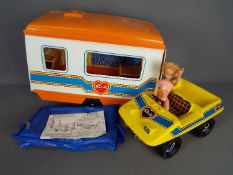 Pedigree - An unboxed vintage Sindy caravan and buggy by Pedigree with an an unmarked naked doll.
