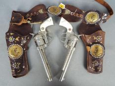 Hubley, Cap Guns - An unboxed pair of vintage diecast 'Cowboy' cap guns.