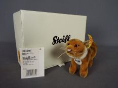 Steiff - a Steiff Radjah Tiger #033346 with yellow label, button in ear and tag under chin,