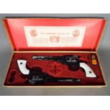 BCM (Derby), Cap Guns - A vintage boxed 'Outlaw Guns' toy cap gun set by BCM.