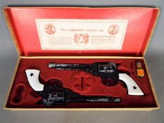 BCM (Derby), Cap Guns - A vintage boxed 'Outlaw Guns' toy cap gun set by BCM.