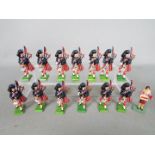 Britains - A small unit of unboxed Britains marching Highlander Pipers soldiers and a Poppy Seller.