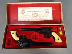 BCM (Derby), Cap Guns - A vintage boxed 'Outlaw Guns' toy cap gun set by BCM.