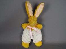 An unmarked vintage yellow mohair and chenille soft toy rabbit,