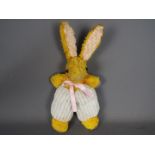 An unmarked vintage yellow mohair and chenille soft toy rabbit,