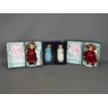 Atlas Editions - Four boxed porcelain dolls on stands in various attire,