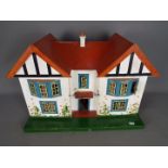 Triang - A wooden Dolls House possibly by Triang together with contents .