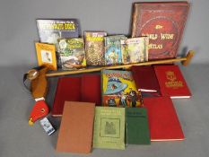 A vintage children's wooden push-along duck with an assortment of books plus some vintage comics,