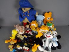 A menagerie of soft plush cuddly toys with a small quantity of unboxed diecast vehicles.
