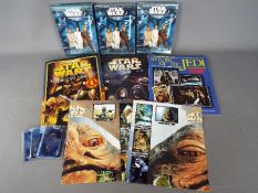 Star Wars, Panini, Merlin - A collection of Star Wars themed sticker albums and trading cards.