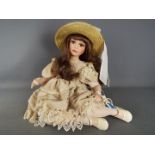 Alberon - A limited edition porcelain dressed doll by Alberon in the form of a young girl seated,