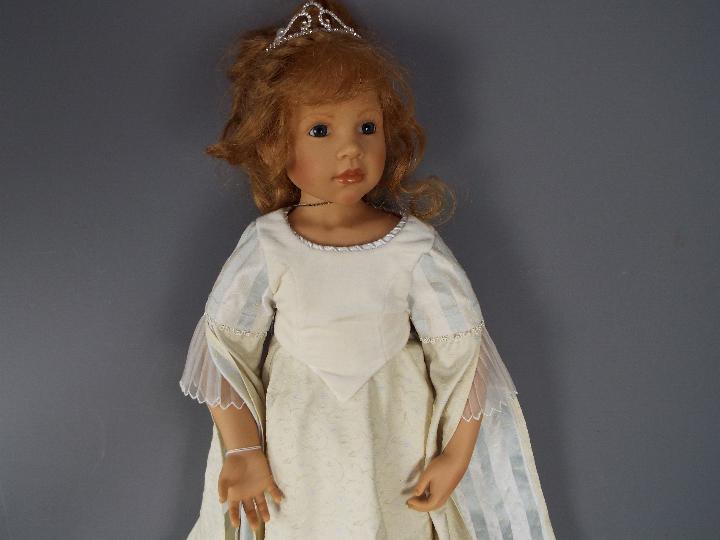 A good quality vinyl dressed doll modelled as a young girl, wearing tiara and necklace, - Image 4 of 5