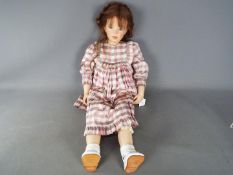 A vinyl dressed doll of a young girl likely by Waltershauser Puppenmanufaktur,