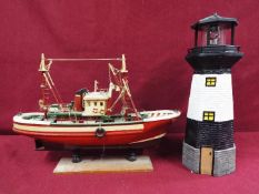 An unmarked wooden static display boat on stand,