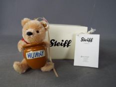 Steiff - A boxed, limited edition Steiff 'Winnie The Pooh with Honey Pot' ornament, # 682933,