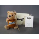 Steiff - A boxed, limited edition Steiff 'Winnie The Pooh with Honey Pot' ornament, # 682933,