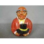 A vintage, American, ceramic money bank in the form of a bust of 'Uncle Mose',