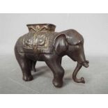 A vintage, cast iron, money bank in the form of an elephant,