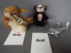 Steiff - three Steiff Animals to include a Panda #039423, a Kecki #070075 and a Dolphin #035708,