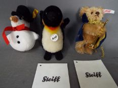 Steiff - three Steiff soft toys to include a Steiff Penguin #040740 with button and yellow tag,