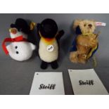 Steiff - three Steiff soft toys to include a Steiff Penguin #040740 with button and yellow tag,